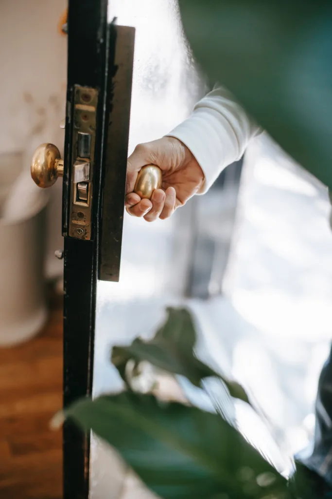 background image of an ypsilanti realtor opening an antique frontdoor