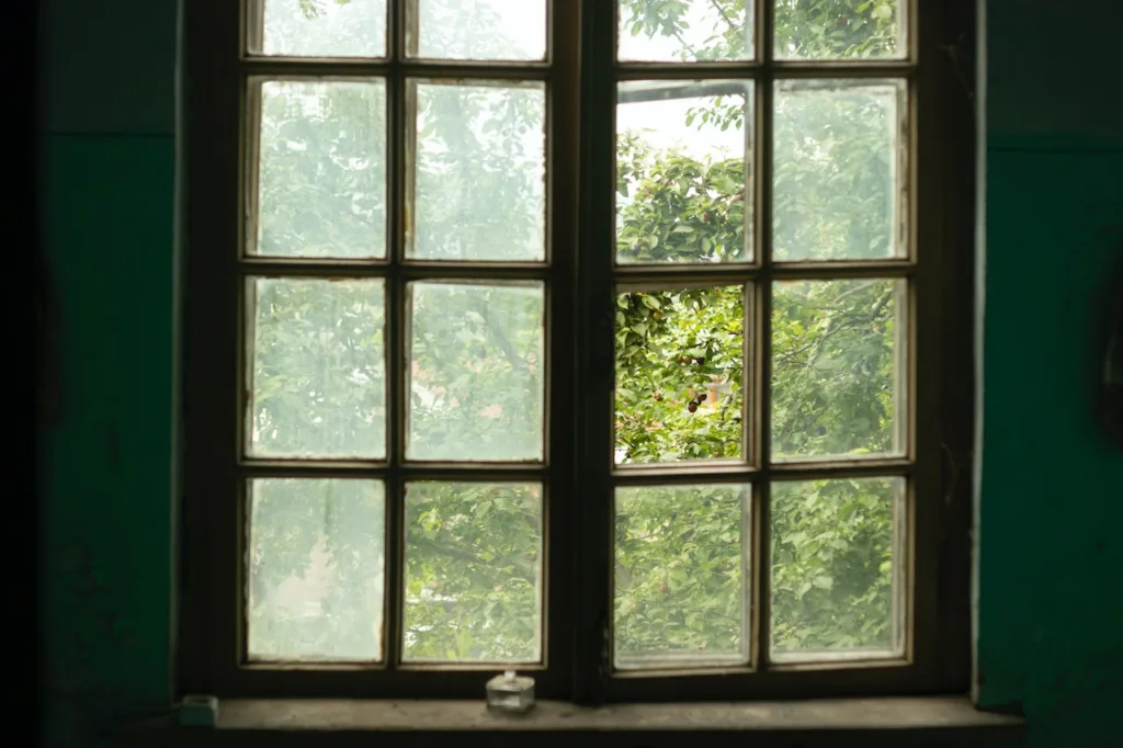 an old window from a historic property which is missing a pane of glass