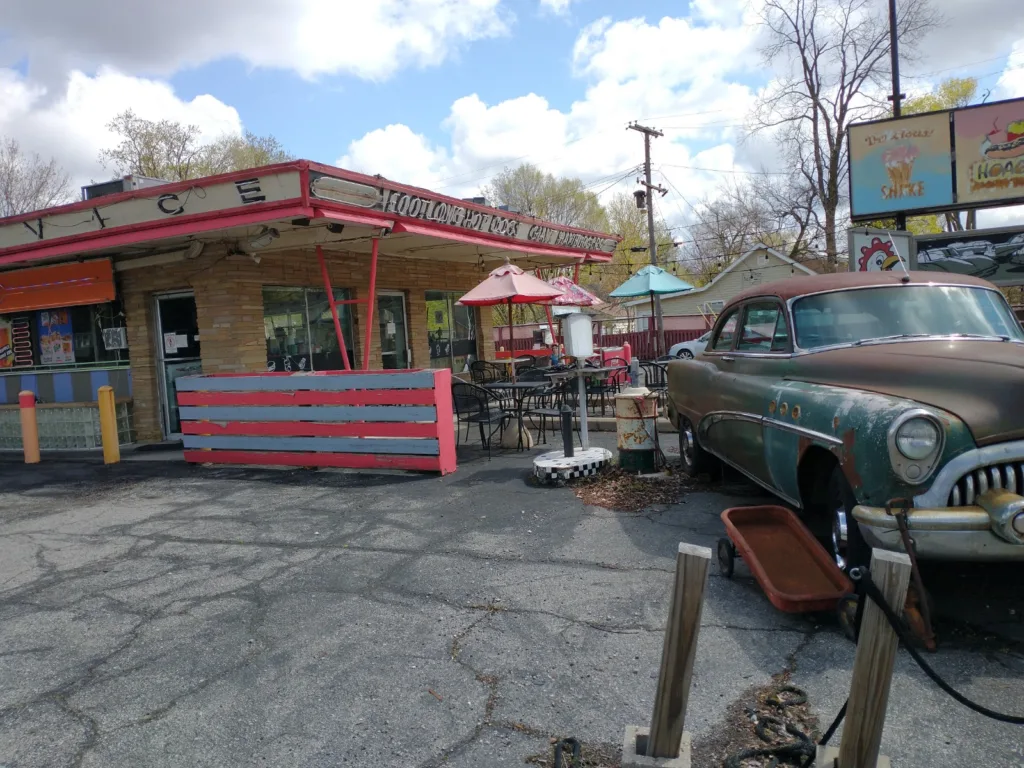 a photo of the chick inn with an antique car and decor